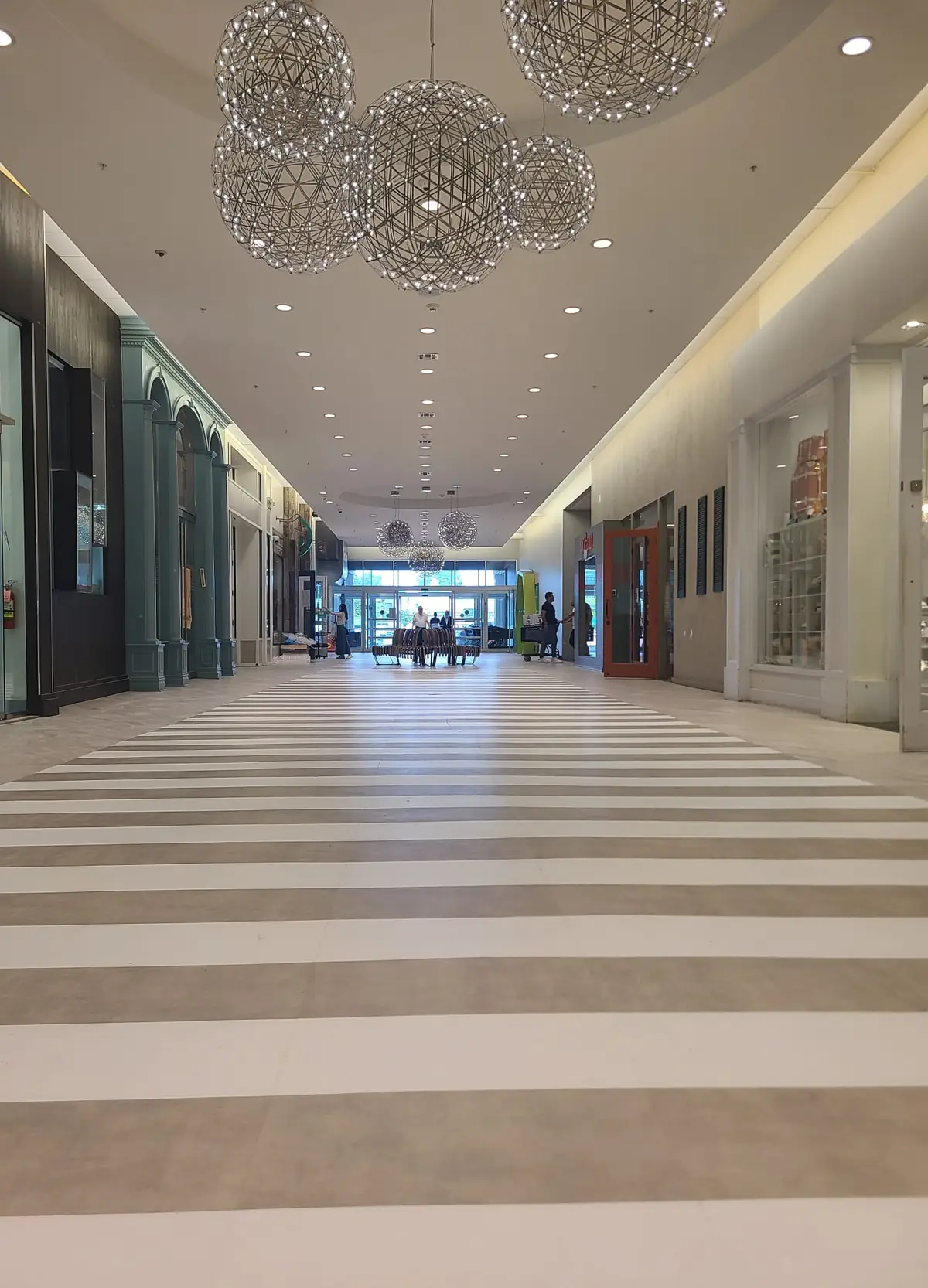 Striped two-tone tile floor in a long commercial corridor, installed by Hudson Valley Carpets