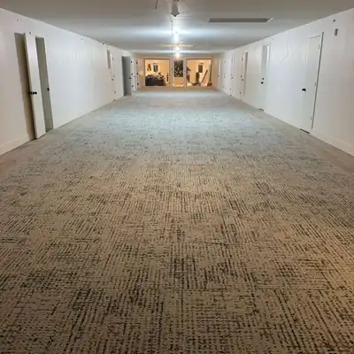 Patterned carpet tile installed down a long commercial corridor