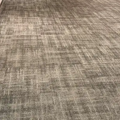 Gray textured carpet installed in an office elevator lobby