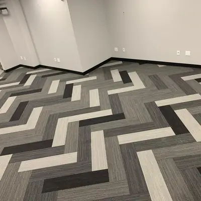 Black, gray and white geometric patterned carpet tile in an open office