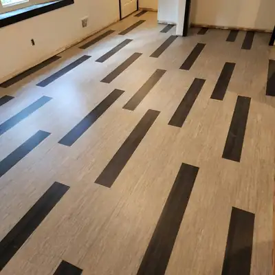 Light vinyl plank floor with dark accent strips in a commercial space