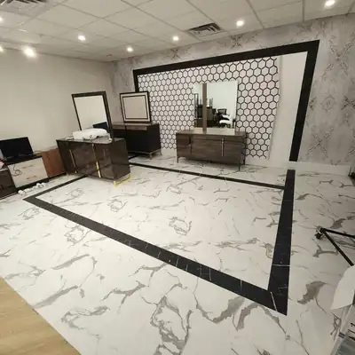 Marble-look LVT with a black border in a commercial suite