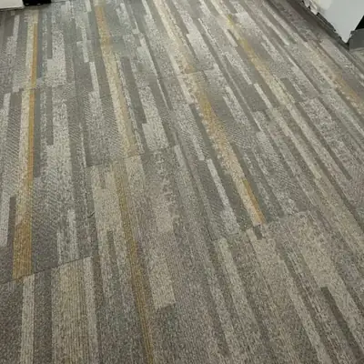 Striped gray carpet tile installed in an office by glass doors