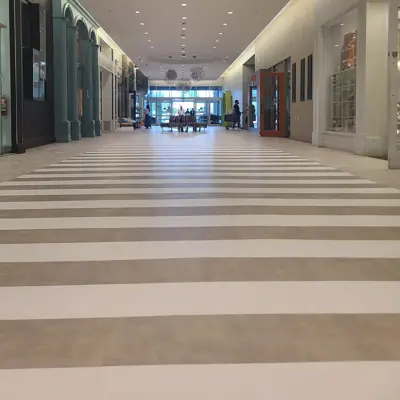 Striped two-tone tile floor in a long commercial corridor, Hudson Valley Carpets
