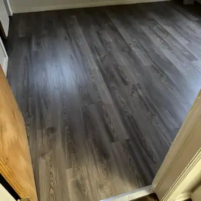 Dark gray luxury vinyl plank installed in a bedroom