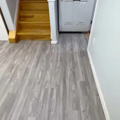Gray vinyl plank flooring in a home entry hallway