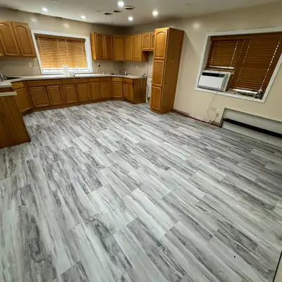 Gray vinyl plank flooring installed in a kitchen