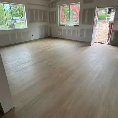 Light oak vinyl plank installed in a new-construction room