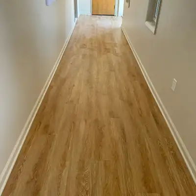 Light oak luxury vinyl plank installed in a hallway