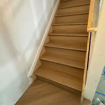 Oak-look vinyl stair treads installed on a staircase