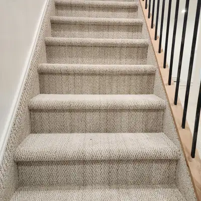 Carpeted stairs with black spindles in a home